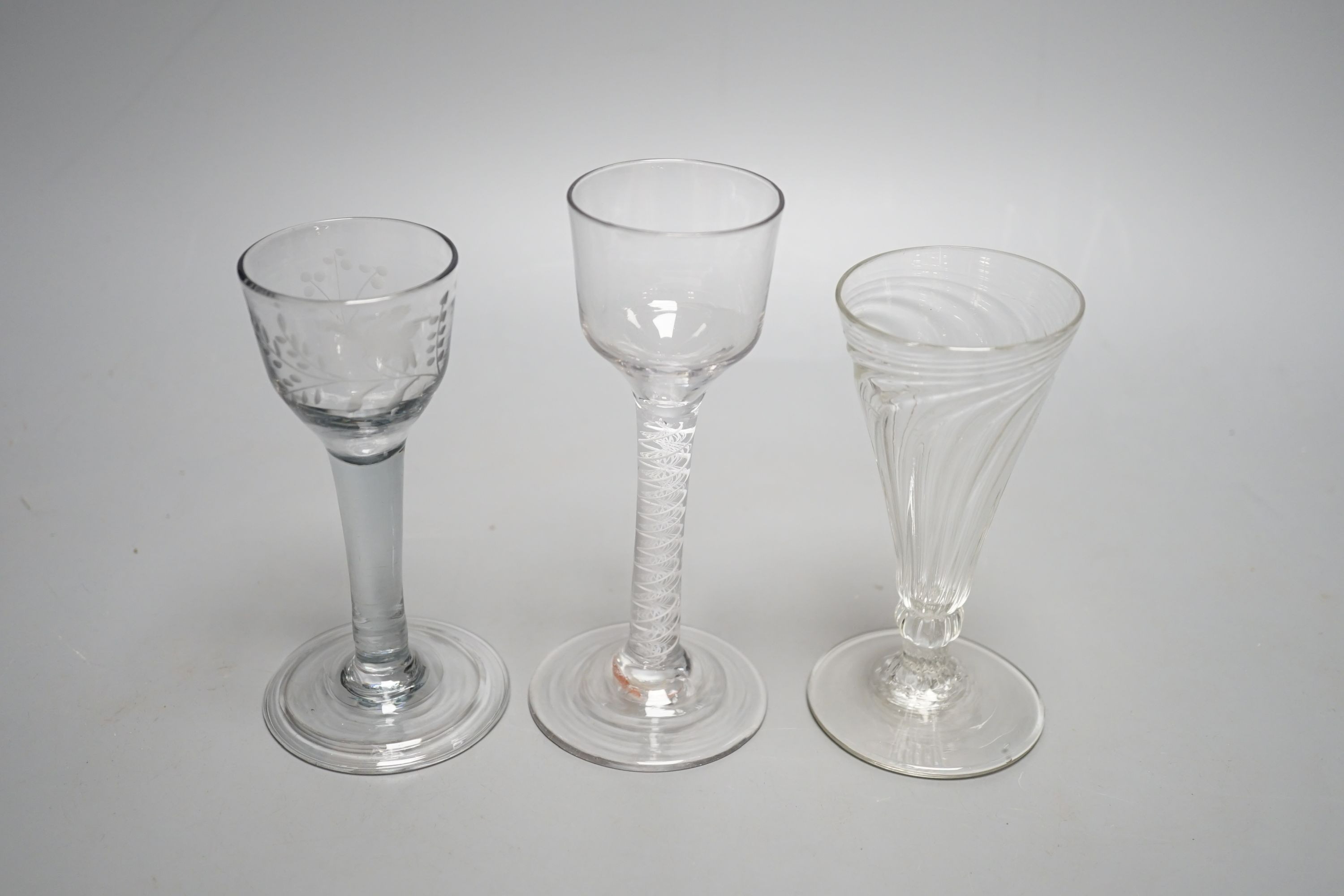 A George III opaque twist stem cordial glass, a George II cordial glass with folded foot and a wrythen twist ale glass (3) - tallest 15cm